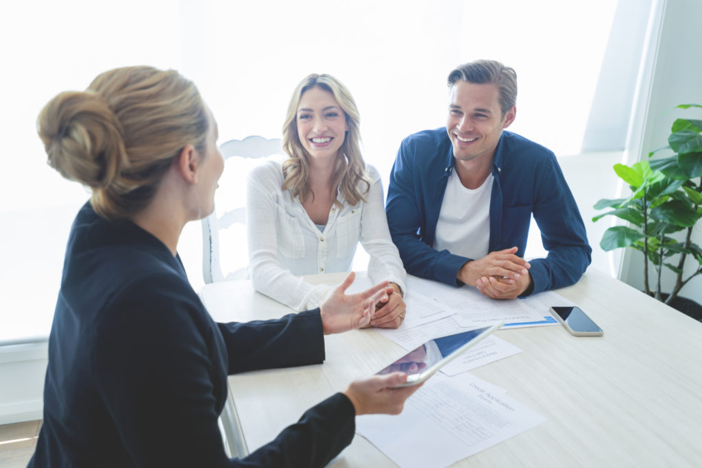 Agent talking to clients at table