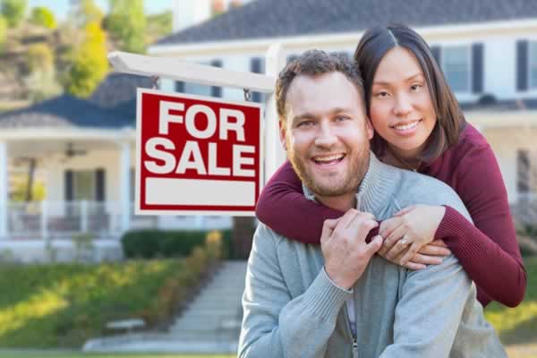 Couple in front of home