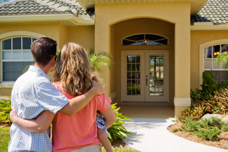 Couple in front of home