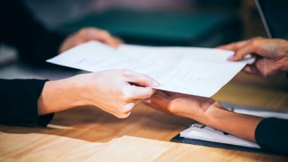 Document being handed to a person