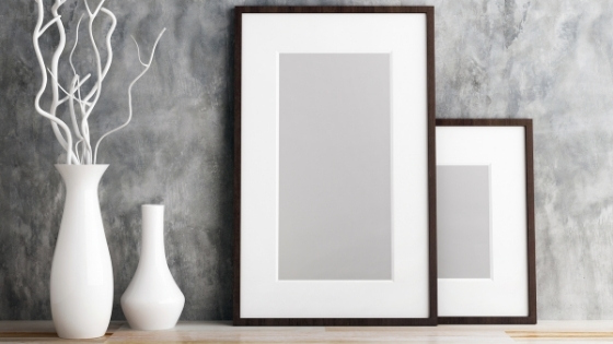 Framed artwork on shelf