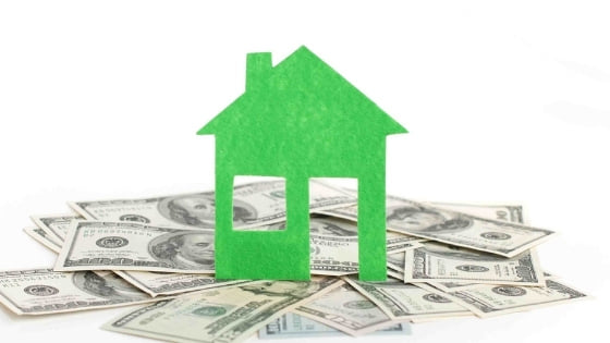 Drawing of house sitting on cash