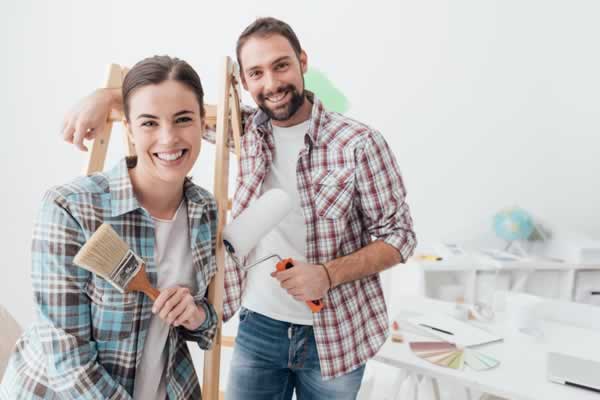 Couple with ladder and paint brushes
