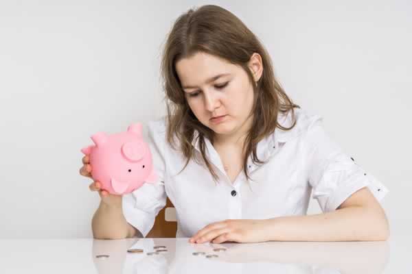 Woman with empty piggybank