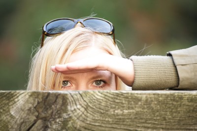 Woman peaking over fence