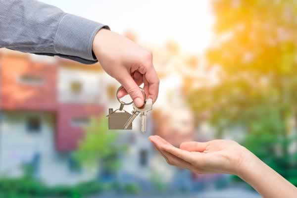 Handing over keys to new home owner