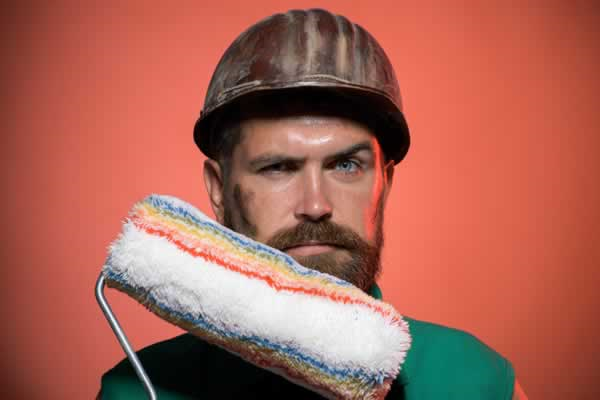 Workman holding paint roller