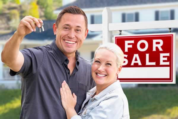 Couple in front of home