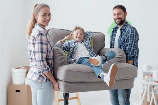 Mom and Dad holding a chair with kid in it