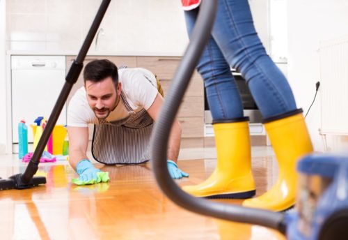 Couple cleaning floor