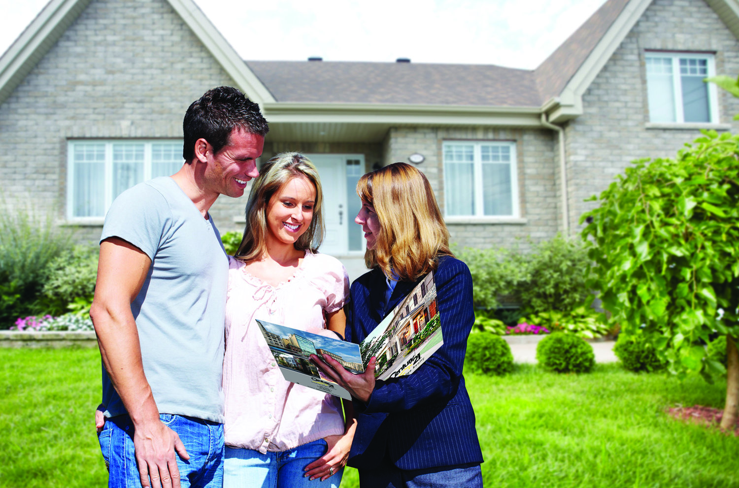 Couple in front of home with realtor