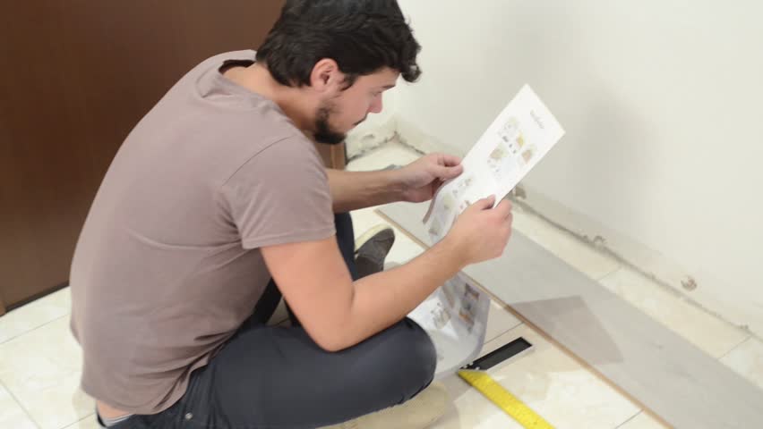 Man reading home repair instructions