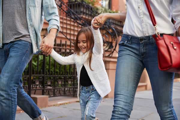Family walking down sidewalk